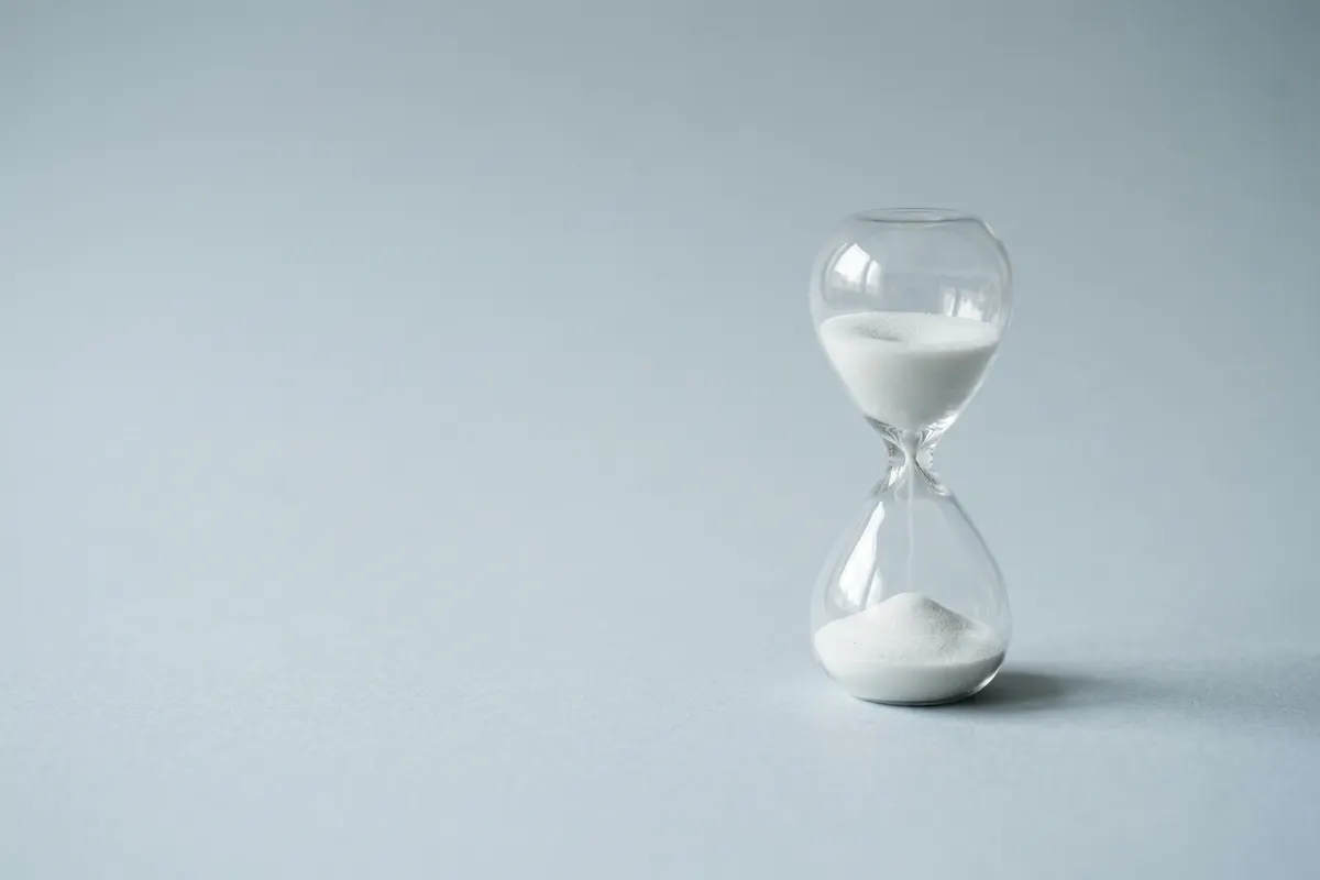 An hourglass with its sand half run through