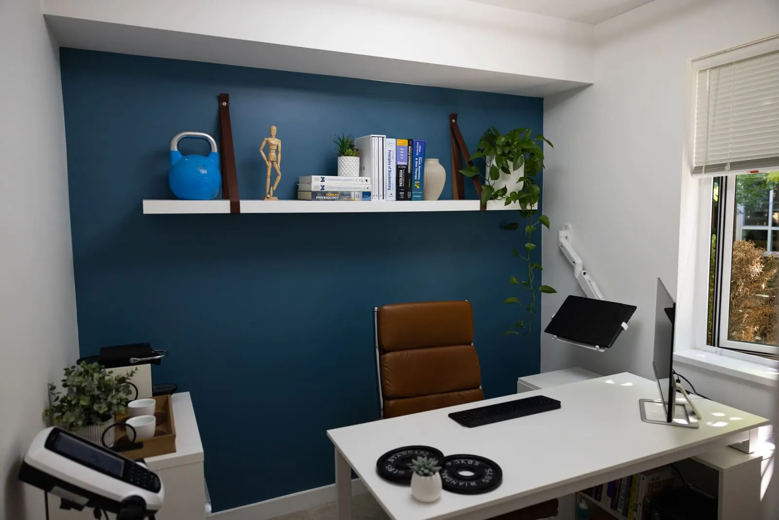 The Port Coquitlam office: desk, chair, bookshelf and the window